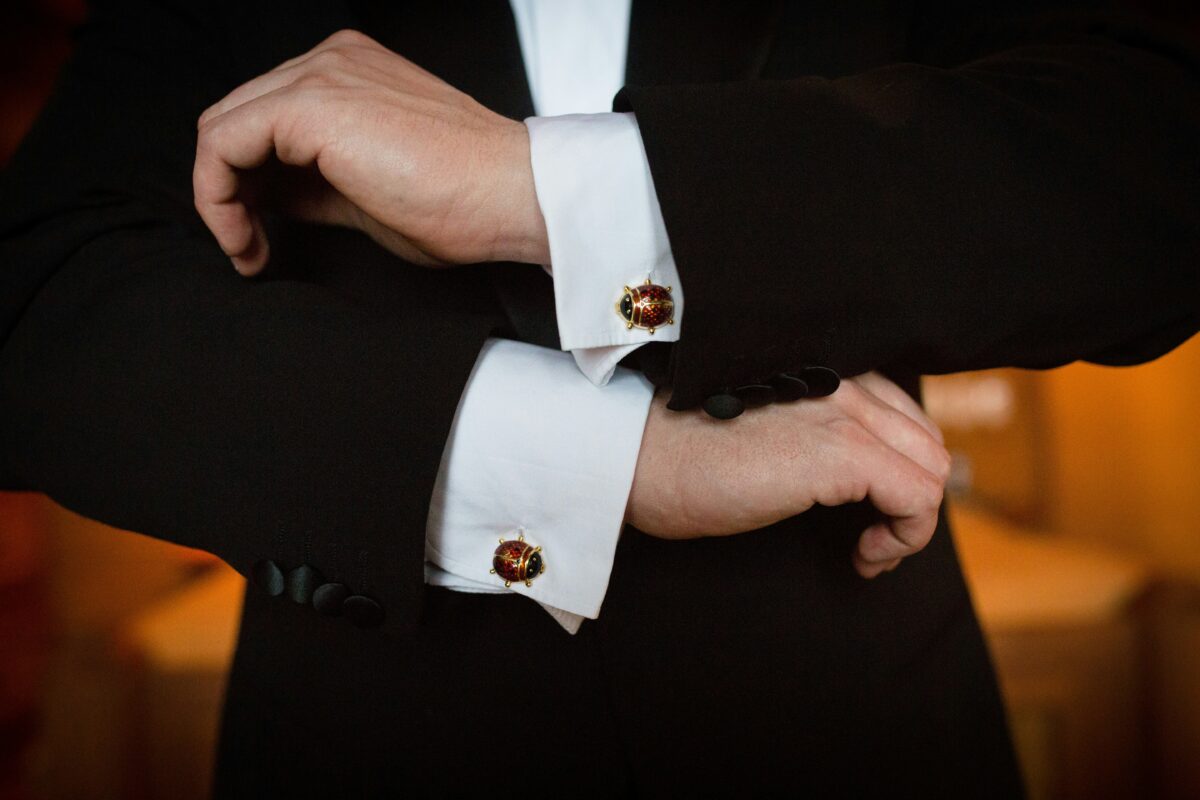 person-wearing-white-dress-shirt-and-black-and-white-beaded-bracelet