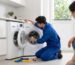 Professional engineer repairing washing machine in modern London home